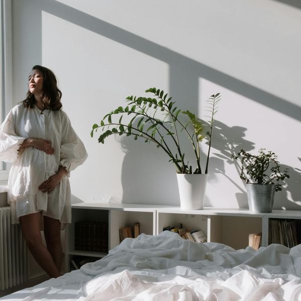 A person meditating peacefully by a window with soft morning light.